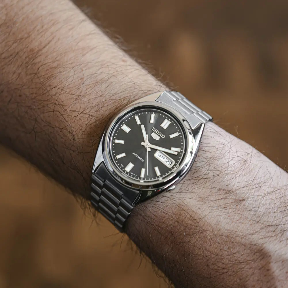 Seiko 5 SNXS79K1 black sunburst dial watch angled view